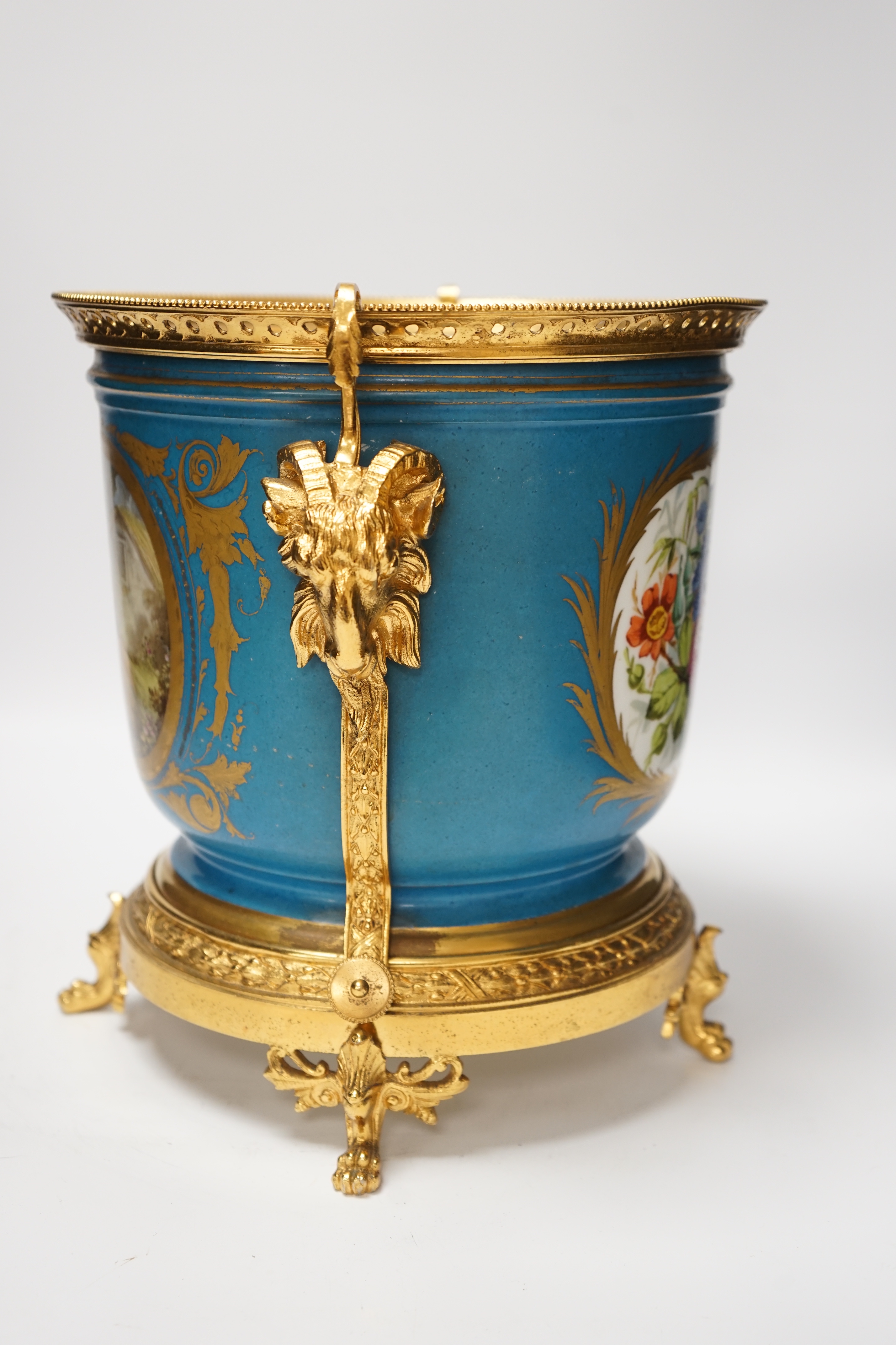 A late 19th century Sevres style jardiniere, turquoise ground with gilt rams head metal mounts, 28cm high